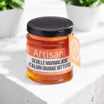 The Artisan Kitchen Seville Orange Marmalade Italian Orange Bitters on a white concrete countertop