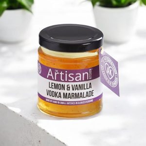The Artisan Kitchen Lemon Vanilla Vodka Marmalade on a white concrete countertop