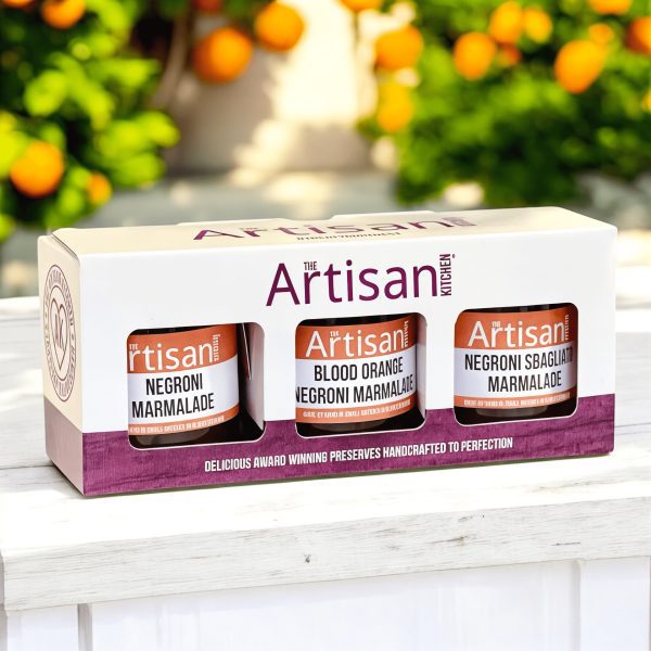 The Artisan Kitchen Three Negroni marmalades gift pack citrus trees in the background